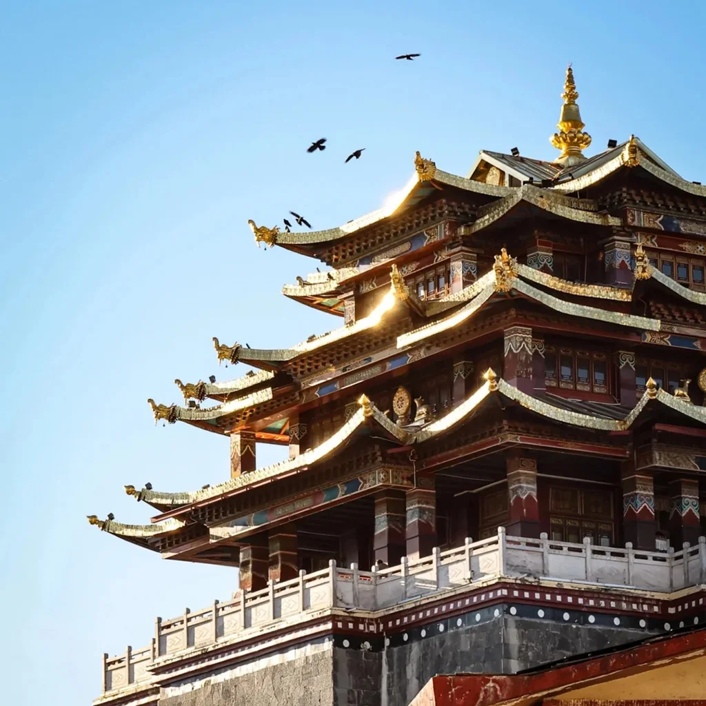 晨光下的 獨克宗古城 建築金頂閃耀，飛簷層疊，展現濃厚藏式風格。